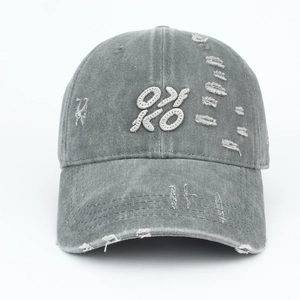 Detail showing vintage washed grey fabric with OX KO embroidery and distressed ripped holes