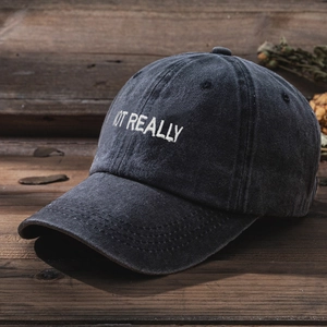 Close-up of NOT REALLY embroidery on vintage washed cotton baseball cap in dark grey