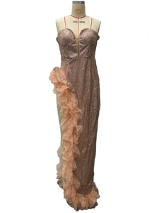 Detail of rose gold sequin gown featuring a high slit and layered pink tulle ruffles