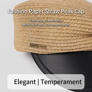 Asymmetric paper straw baker boy hat with black leather brim and metal honey bee tag
