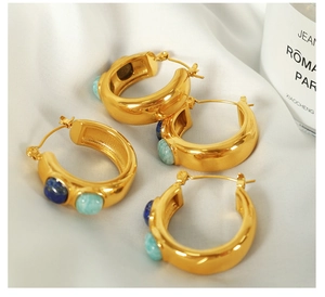 Detailed view of 18k gold plated C-shape earrings with inlaid blue natural stones