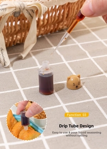 Detailed view of mini condiment bottle with cat-shaped cap and leak-proof dropper tube