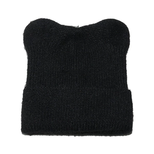 Close-up of black ribbed knit beanie with cute cat ear design on a white background