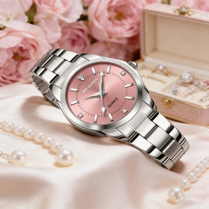 Detail of pink dial watch with silver metal band among roses and elegant pearls