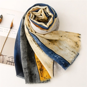 Detailed view of the soft ink-wash geometric print scarf with delicate fringed edges