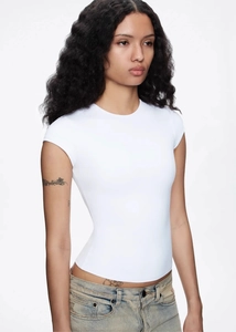 Close-up of high-elasticity white slim fit t-shirt with short sleeves for women