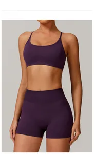 Detail view of plum purple seamless yoga set with ribbed knit texture and spaghetti straps