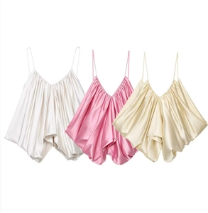Detailed view of satin camisole tops in white, pink, and champagne gold colors
