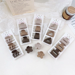 Three-piece matte hair claw set in brown earth tones with minimalist geometric floral shapes