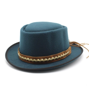 Vintage wool felt boater hat in dark teal blue with a brown woven leather hatband