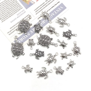 Macro view of assorted antique silver turtle alloy charms for DIY jewelry making