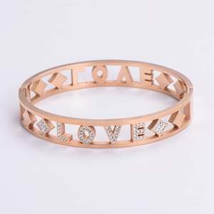 Detailed macro view of rose gold LOVE hollow bracelet with white crystal rhinestones