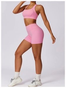 Detailed side view of pink high-waist yoga set showing elastic fabric and slim fit design