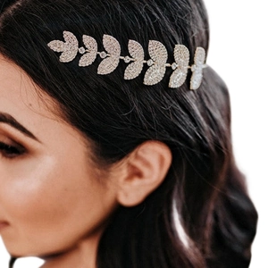 Elegant gold leaf headband with rhinestones shown on model for bridal hair accessory