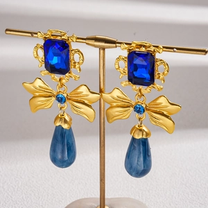 Vintage gold earrings with blue square gems, bow accent and teardrop pendants