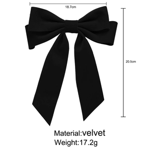 Detail view of a large black velvet bow hair clip with ribbons, size 18.7cm by 20.5cm