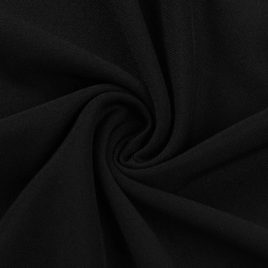 Close-up of black knitted fabric texture with fine weave patterns on a slim-fit dress