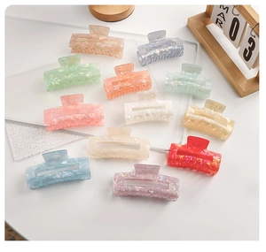 Detailed overhead view of 11 colorful matte hair claw clips in various candy tones