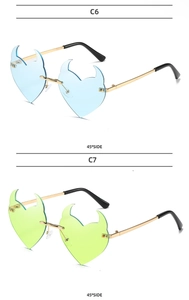 Detail view of heart-shaped rimless sunglasses in light blue and neon green with gold temples