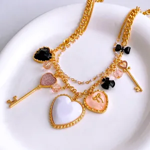 Collana vintage multistrato in oro con ciondoli a cuore e chiave da donna