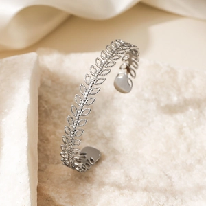 Minimalist silver wheat ear open bangle in stainless steel on white stone
