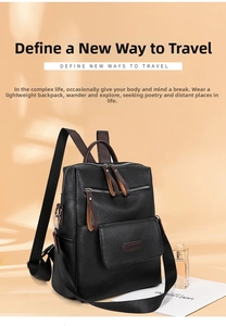 Detail view of black lychee-grain PU leather backpack with brown zipper pulls and metal logo