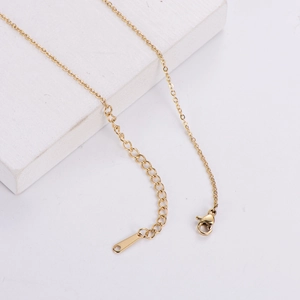 Gold cube necklace with Roman numerals pendant featuring extension chain and lobster clasp
