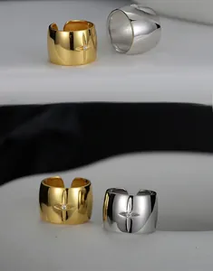 Macro view of adjustable wide band starburst ring with cubic zirconia in silver and gold