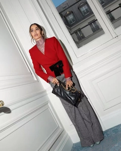 Detail of red blazer with black velvet bow and pleated waist for Christmas outfit