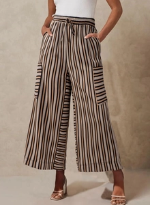 Close-up of vertical striped wide leg pants featuring drawstring waist and side pockets
