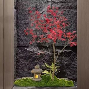 Zen garden detail with red maple leaves, stone lantern and realistic artificial moss
