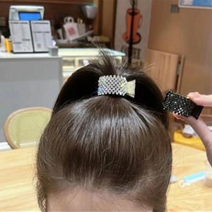 Detail of a high ponytail clip with sparkling rhinestones in a bunny zodiac design