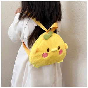 Detailed view of plush yellow chick cartoon backpack on young girl in white dress