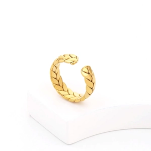 Close-up of golden wheat braided texture on an adjustable titanium steel ring
