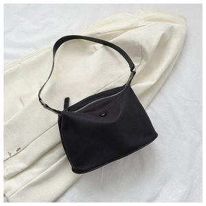 Top view of a black nylon shoulder bag with silver zipper and buckle on a white background