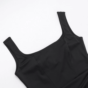 Detail of square neckline and wide shoulder straps on a sleek black sleeveless dress