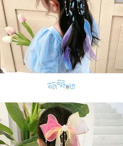 Detail of gradient ribbon hair clips with pearl tassels and colorful bows for girls