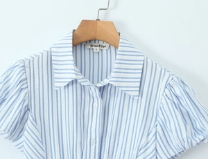 Detailed view of puff sleeves and lapel collar on a blue striped short sleeve shirt
