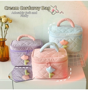 Detailed view of quilted corduroy makeup bags in pastel colors with floral zipper pulls