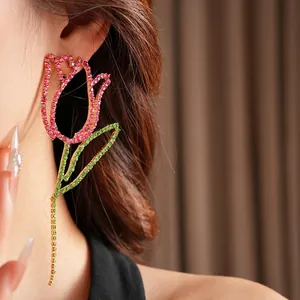 Pink tulip drop earrings with green crystal inlay and long tassel worn by model