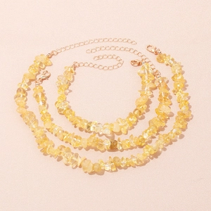Close-up of three natural yellow stone bracelets with adjustable gold lobster clasps