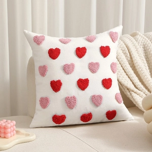 White polyester-cotton pillow with tufted red and pink 3D embroidered hearts