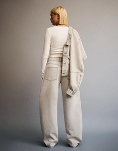 Detailed back view of high waist wide leg denim trousers in light gray wash