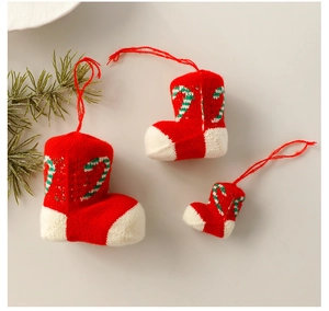 Three-piece set of knitted Christmas stocking ornaments with festive candy cane patterns
