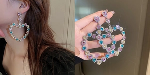 Detailed view of oversized hollow heart earrings featuring colorful pavé crystals