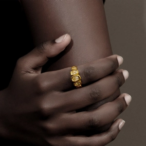 Detail of 18K gold plated ring with geometric yellow cubic zirconia on finger
