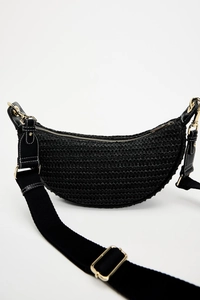 Detailed macro view of black woven moon bag featuring adjustable strap and gold hardware