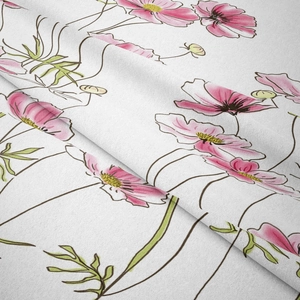 Close-up detail of bohemian tapestry fabric showing pink floral patterns and texture