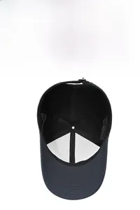 Detail view of breathable side mesh and interior stitching on a black baseball cap