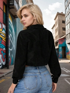 Street style black corduroy cropped jacket with lantern sleeves shown from a back side angle